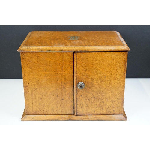 104 - Antique oak smokers cabinet with opening doors, pipe racks, three drawers and lift up lid with ashtr... 