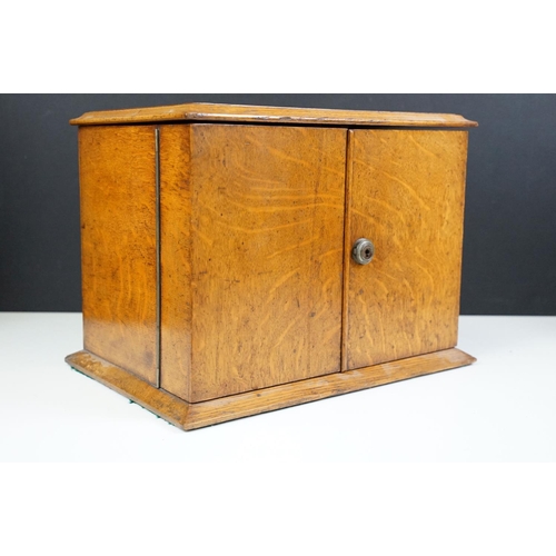 104 - Antique oak smokers cabinet with opening doors, pipe racks, three drawers and lift up lid with ashtr... 