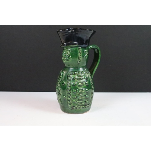 18 - Hungarian Folk Art green glazed wine pitcher in the form of a soldier, 20cm high