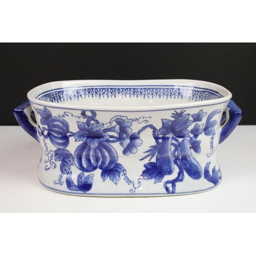 36 - Stoneware twin handled blue and white footbath decorated with fruits and foliage, 34cm long