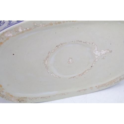 36 - Stoneware twin handled blue and white footbath decorated with fruits and foliage, 34cm long