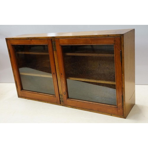 109 - Early 20th century mahogany and pine folding double display cabinet, each glazed door opening to rev... 