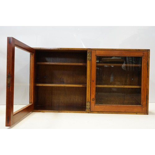 109 - Early 20th century mahogany and pine folding double display cabinet, each glazed door opening to rev... 