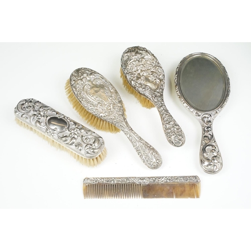 297 - Antique dressing table set of silver ornate embossed hairbrushes and comb together with silver plate... 