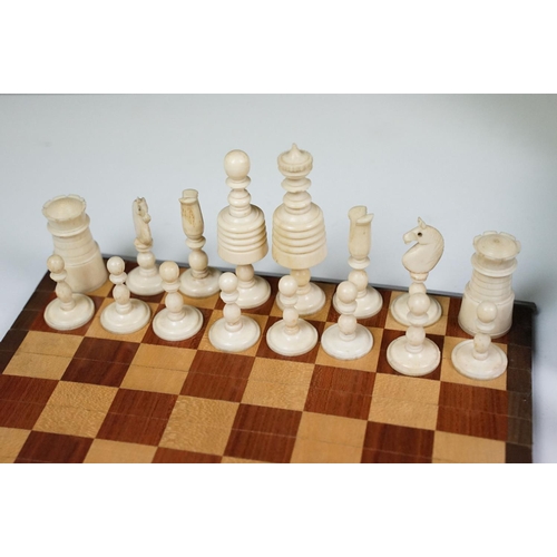 300 - Early 20th century Small box of travel chess pieces and roll out mat board.