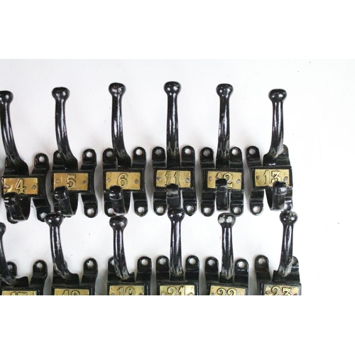 304 - Set of fifteen vintage cast iron coat hooks with gold coloured numbering