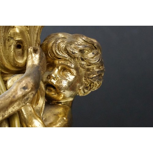 146 - Gilt metal table lamp modelled as two putto, with a red marble base with gilt metal mounts (detached... 