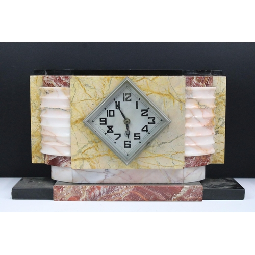 121 - Art Deco marble clock garniture set, comprising: time piece flanked by two pedestal pots, the clock ... 