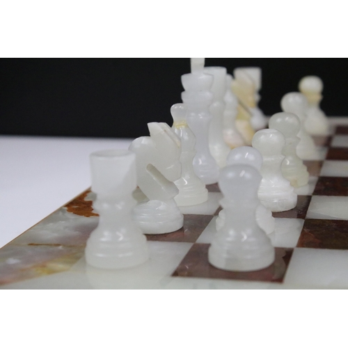 130 - Marble / alabaster chess board with chess set (32 pieces), the board 39.5 x 40.5cm (excluding wooden... 