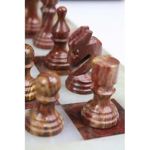 130 - Marble / alabaster chess board with chess set (32 pieces), the board 39.5 x 40.5cm (excluding wooden... 