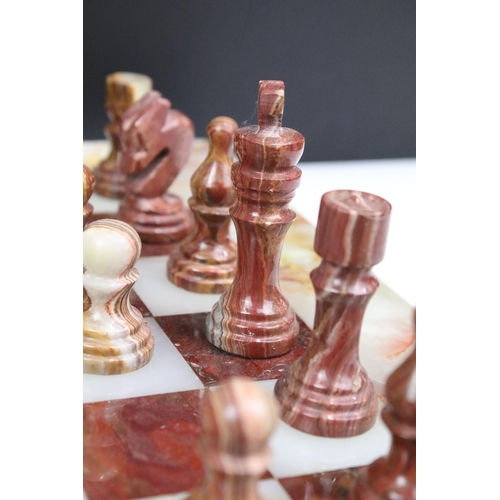 130 - Marble / alabaster chess board with chess set (32 pieces), the board 39.5 x 40.5cm (excluding wooden... 