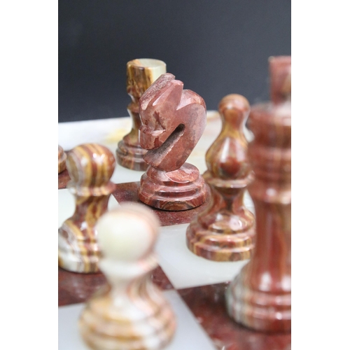 130 - Marble / alabaster chess board with chess set (32 pieces), the board 39.5 x 40.5cm (excluding wooden... 