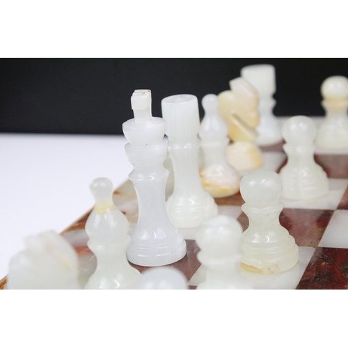 130 - Marble / alabaster chess board with chess set (32 pieces), the board 39.5 x 40.5cm (excluding wooden... 