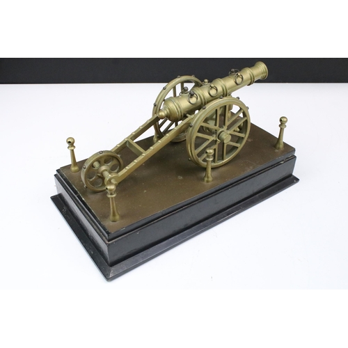 153 - Decorative brass tabletop cannon with cannonballs on plinth, W 33cm, D 18cm, H 16.5cm