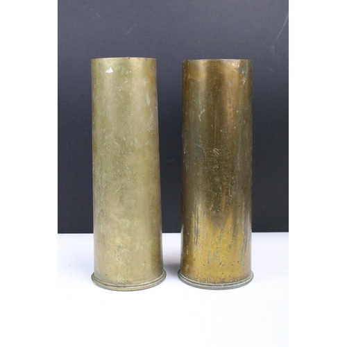 161 - Two 1955 brass trench art shell vases, H 29cm together with a metal flask