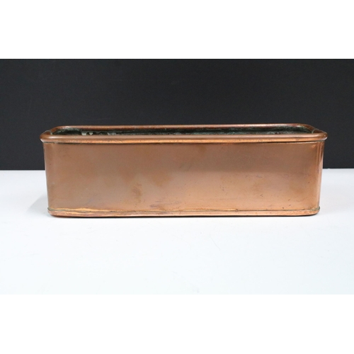 167 - Copper planter of rectangular form with rolled rim and curved ends, 30cm long