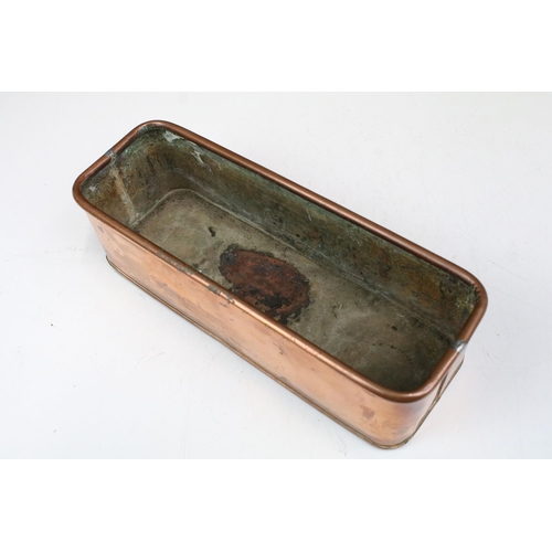 167 - Copper planter of rectangular form with rolled rim and curved ends, 30cm long