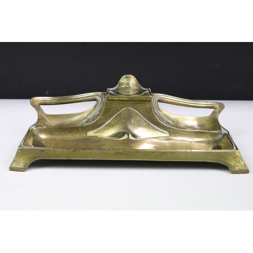 169 - Art Nouveau brass standish or desk stand with central single inkwell, 26cm long