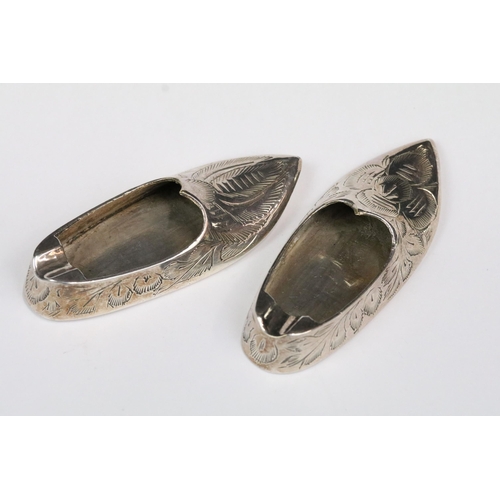 180 - A pair of Indian silver miniature ashtrays in the form of slippers.