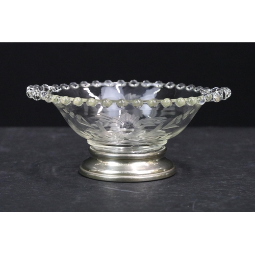 182 - Sterling silver and glass twin handled bowl with glass beaded edge and etched with flowers raised on... 