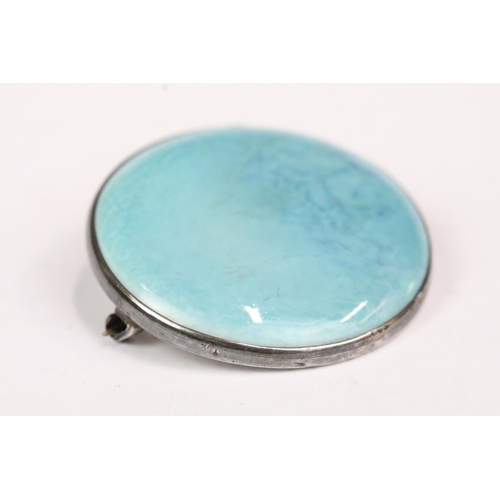 191 - Ruskin brooch, the circular turquoise plaque held in a hallmarked silver mount, 3.5cm diameter