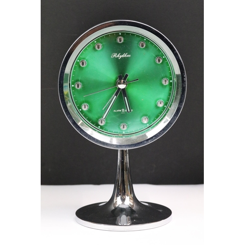 200 - A mid 20th century Rhythm 2 jewel Japanese made alarm clock with green metallic dial.