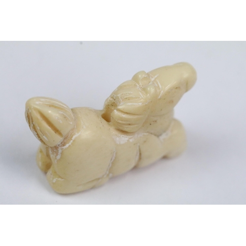 207 - Four carved bone miniature netsuke figures to incude signed dragons head, snake coiled around gold, ... 