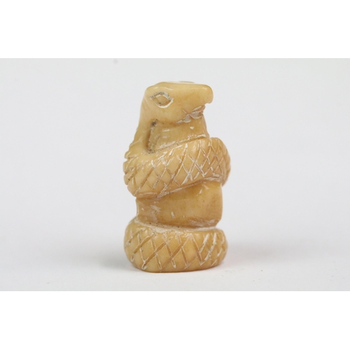 207 - Four carved bone miniature netsuke figures to incude signed dragons head, snake coiled around gold, ... 