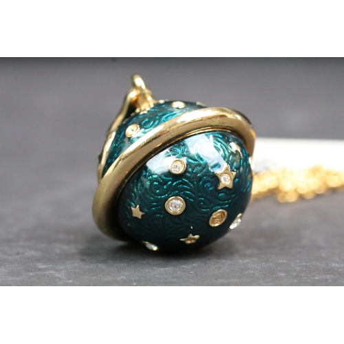 209 - A Swarovski jeweler's collection necklace with enamel planet shaped pendant, complete with display c... 