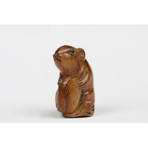 210 - Four carved wood miniature netsuke figures to include signed dog, mouse with nut, rabbit and hen