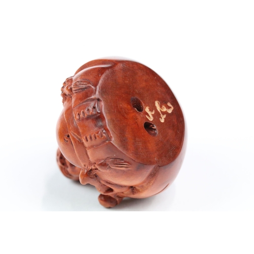 216 - Four wood netsuke figures to include signed seated happy buddha, dog, dragon and foliage/fruit carvi... 