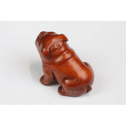 216 - Four wood netsuke figures to include signed seated happy buddha, dog, dragon and foliage/fruit carvi... 