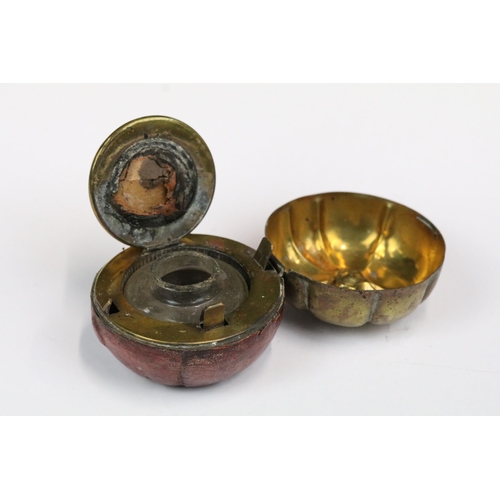 223 - An early 20th century travelling inkwell of fruit form with leather covered base together with a Jad... 