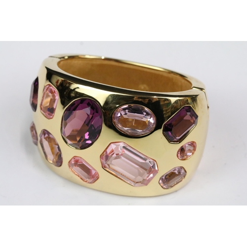 224 - A gold tone Swarovski ladies cuff bangle set with faceted pink crystals, within original box.