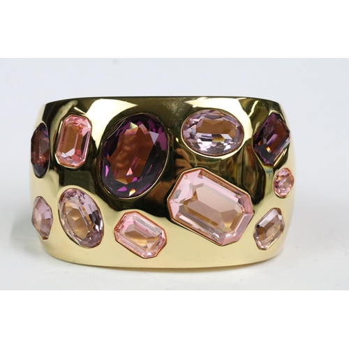 224 - A gold tone Swarovski ladies cuff bangle set with faceted pink crystals, within original box.