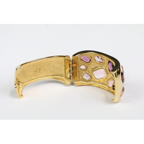 224 - A gold tone Swarovski ladies cuff bangle set with faceted pink crystals, within original box.