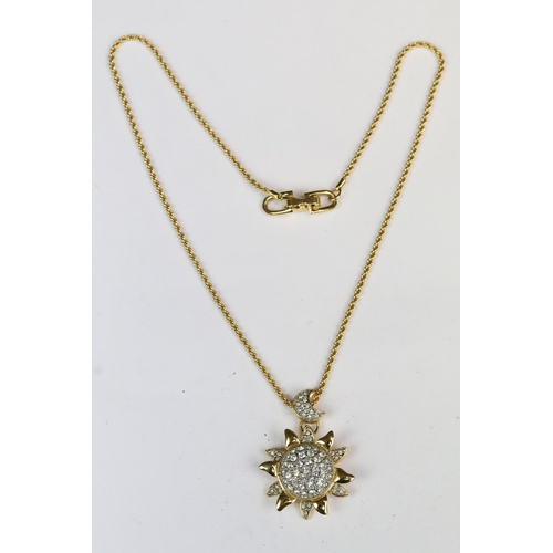 230 - A Swarovski Jeweler's collection gold tone necklace with sun and crescent moon pendant, in fitted di... 