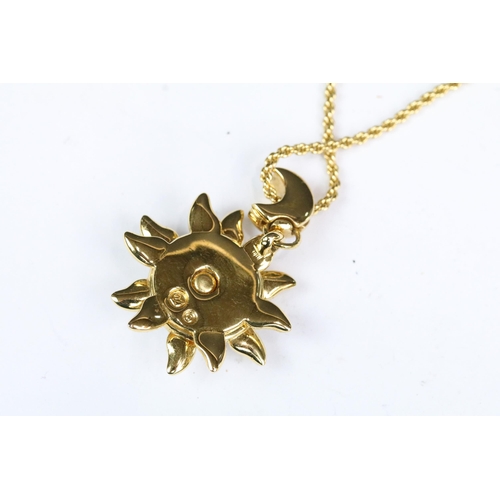 230 - A Swarovski Jeweler's collection gold tone necklace with sun and crescent moon pendant, in fitted di... 