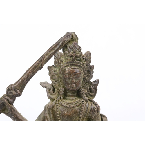 238 - A Chinese ornamental bronze Tara holding sword figure, stands approx 8cm in height.