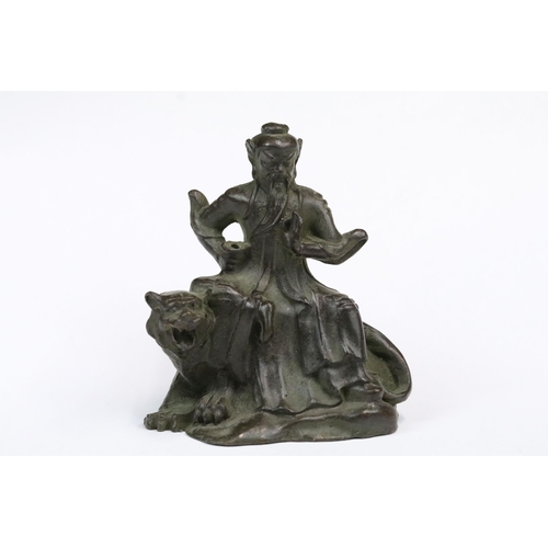 240 - A Chinese ornamental bronze figure / incense burner of man upon tiger, stands approx 6cm in height.