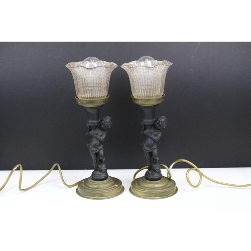 322 - Pair of Art Nouveau style cherub lamps carrying frill hobnail glass shades on rounded base, H 33cm