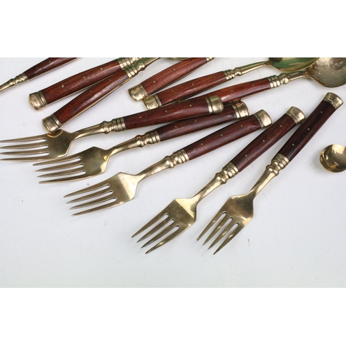 356 - Assortment of wooden handled gold metal cutlery