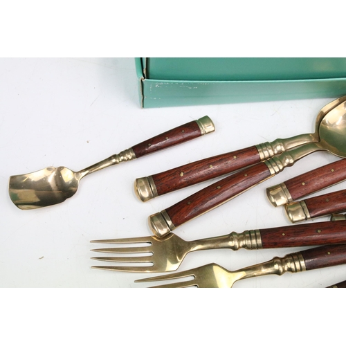 356 - Assortment of wooden handled gold metal cutlery