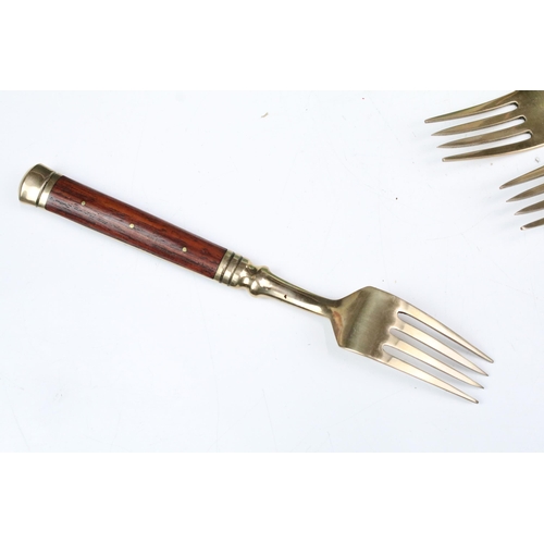 356 - Assortment of wooden handled gold metal cutlery