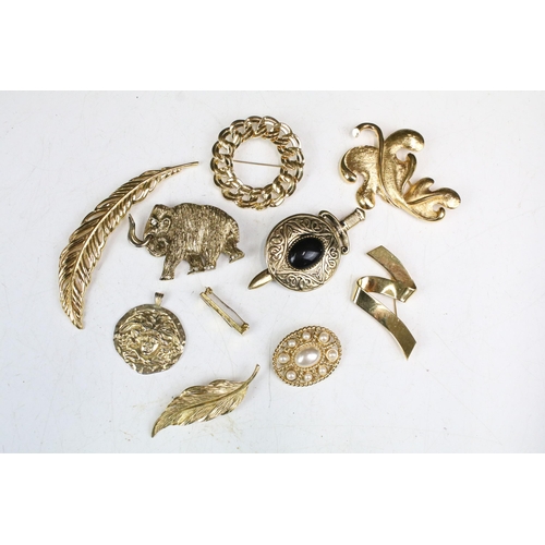 270 - A collection of costume jewellery gold tone brooches to include Monet examples.