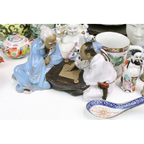 103 - Large assortment of Oriental ceramics to include bowls, plates, ornament figurines, clay mud man orn... 