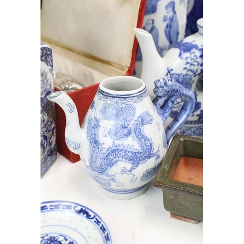 104 - Large collection of Oriental chinaware to include donut teapots, large selection of blue and white p... 