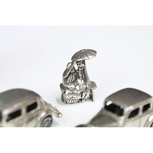 277 - A small group of mainly silver plated miniature collectables to include cars, figures and two baby t... 