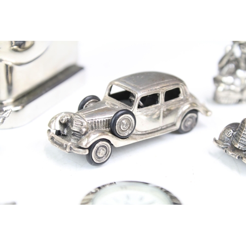 277 - A small group of mainly silver plated miniature collectables to include cars, figures and two baby t... 