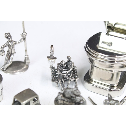 277 - A small group of mainly silver plated miniature collectables to include cars, figures and two baby t... 